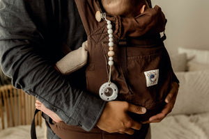Ninni Co. Mist Pacifier Clip attached to front pack.